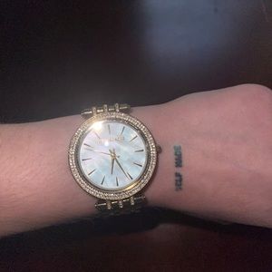 Mother of Pearl face. Open to trades of gold jewelry, designer bags, and shoes.